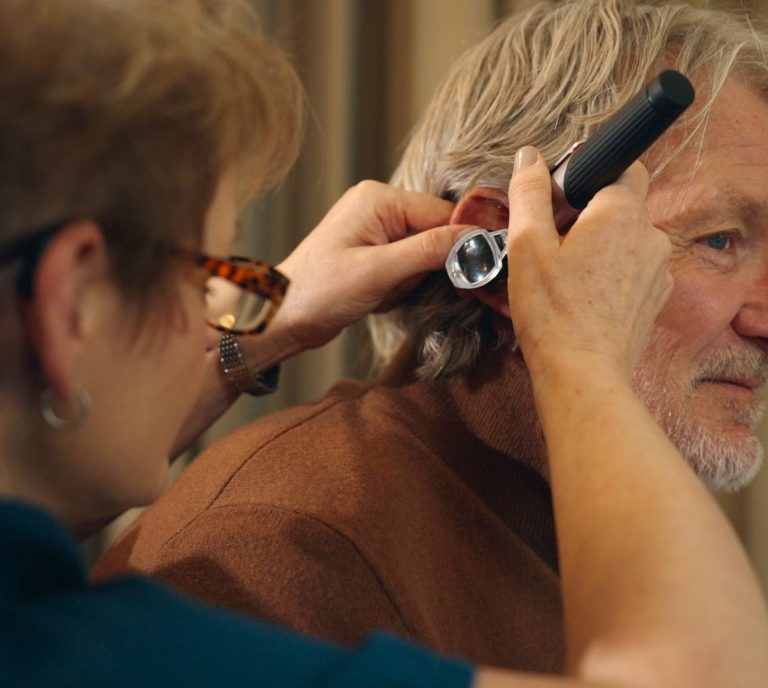 All About Hearing Audiologist, Karen Finch, conducting otoscopy on a patient Audiologist Karen Finch using an otoscope to look in a patient's ear