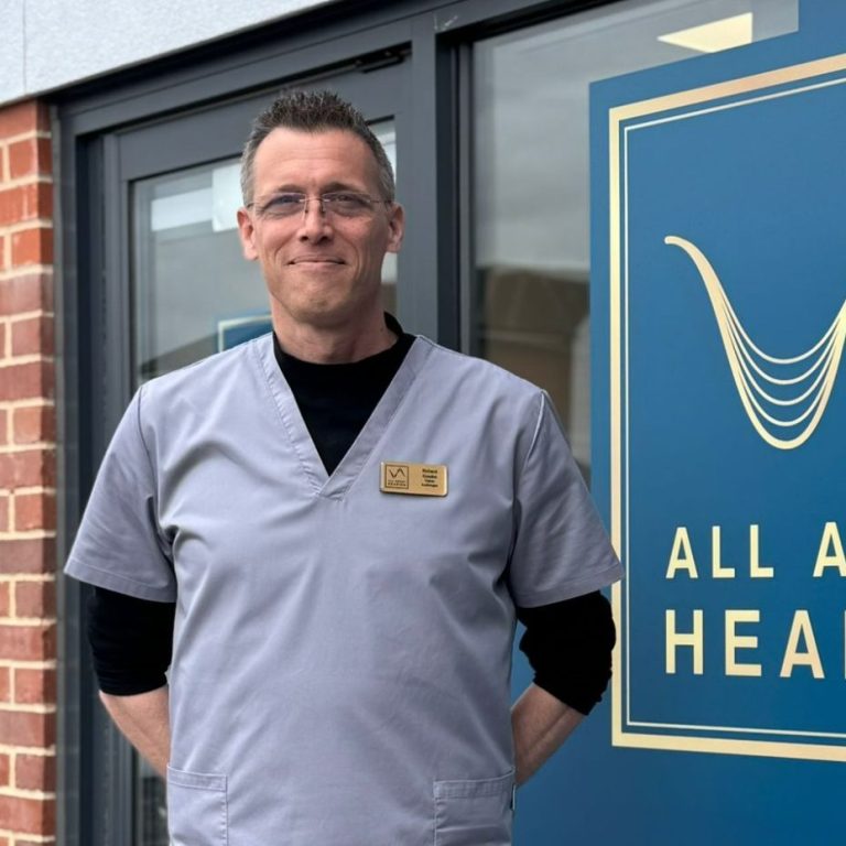 All About Hearing Trainee Audiologist, Richard Cousins, standing outside the front of the Kesgrave practice, smiling