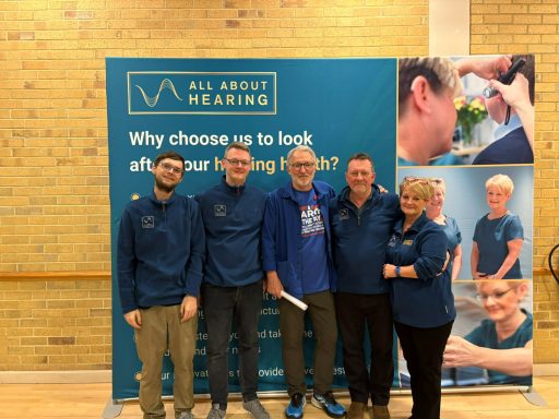 Group photo of staff from All About Hearing, together with ITFC legend Russell Osman. 